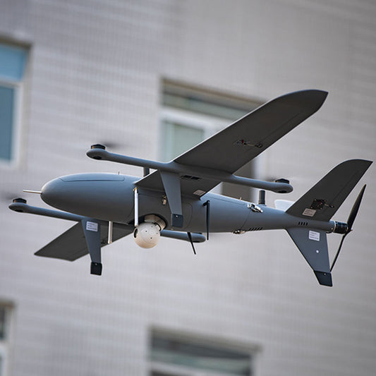 Gray and white fixed-wing UAV with twin wings, mounted sensors, and rear propeller