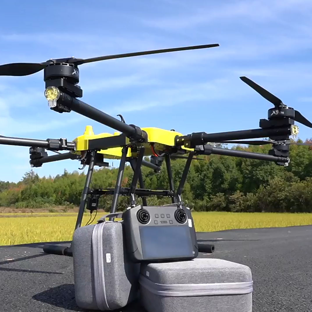 Two-camera cargo drone with bright yellow frame, front remote controller and carrying case