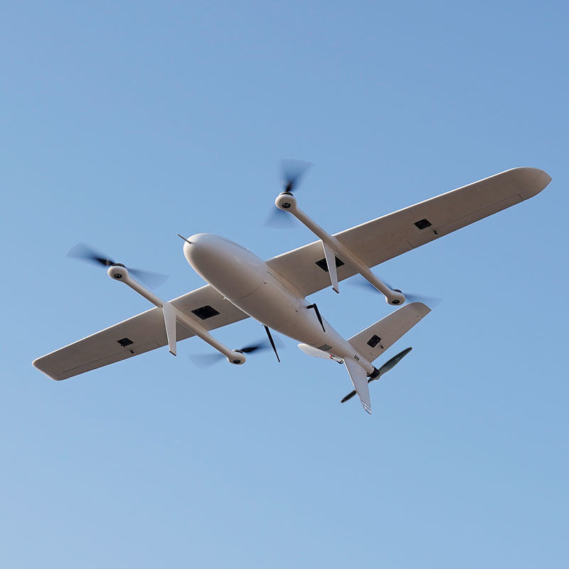 Cream fixed-wing UAVs flying in formation, propellers visible and extended landing gear